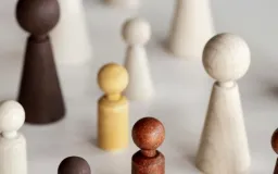 Wooden peg figures of different colours arranged in a group